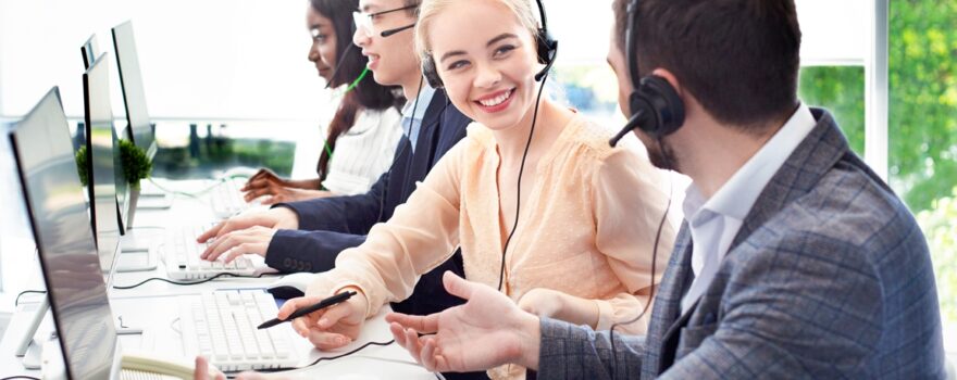 A group of people sitting at a table with headphones on.